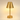 Three-quarter view of the brass cordless table lamp, shade on