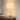 Ribbed glass table lamp on a quiet wood nightstand, shade on