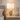 Gold mesh table lamp on a pale oak nightstand, shade on