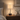 Walnut twist table lamp on a quiet nightstand, shade on