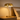 Gold pull-chain table lamp on a quiet nightstand, shade on