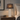 Crystal cylinder table lamp on a quiet wood nightstand, shade on