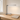 Polished chrome L-shaped LED desk lamp on a light oak writing desk, lamp on