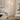 Gold two-globe tree floor lamp beside a sofa, lit