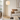 Gold tier floor lamp beside a sofa in a quiet living room, lit