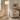 Nickel glass column floor lamp beside a sofa, lit