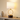 Wood ring table lamp on a console with one ceramic vase, shade on