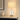 Ribbed glass table lamp on a stone console with a ceramic vase, shade on