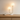 Dual globe table lamp on a light wood console with one ceramic bowl, both globes on