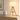 Wood tripod table lamp on a console with one ceramic vase, shade on