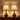 Pair of wood teardrop table lamps together in a quiet room, shades on
