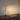 Polished chrome L-shaped LED desk lamp on a walnut console, lamp on
