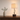 Walnut twist table lamp on a console with one ceramic vase, shade on