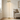 Gold dome floor lamp in a quiet living-room corner, lit