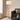 Nickel glass column floor lamp in a quiet living-room corner, lit