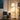 Corner vignette with the Seoul wood-tray floor lamp glowing, one soft prop max.