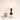 Geometric column table lamp next to a book and mug for scale, shade on
