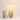 Gold mesh table lamp next to a book and mug for scale, shade on