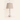 Washed-white spindle table lamp with 23 inch height and 12 inch width overlays, lamp off