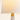 Close-up of the white fabric shade, gold collar, and marble neck, lamp on