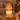 Close-up of the amber glass tree shade over a candle with melted wax