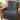 Dark grey chunky knit weighted blanket draped over a leather armchair
