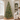 Frosted pre-lit Christmas tree with red berries and pine cones in a living room