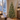 Frosted pre-lit Christmas tree in a dining room with snow outside