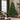 Full green Christmas tree beside a tall window