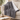 Gray sherpa heated throw blanket draped over a sofa