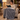 Woman reading in an armchair with the gray sherpa heated throw over her lap