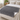 Gray sherpa heated throw blanket laid across the foot of a bed with one corner turned back