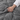 Close-up of a hand gathering the quilted gray weighted throw blanket