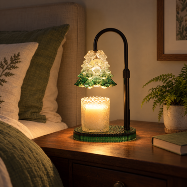 Green Glass Tree Candle Warmer Lamp on a dark wood nightstand at night