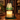 Close-up of the green and clear glass tree shade over a candle with melted wax
