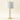 White marble table lamp with four stacked discs and a white drum shade, lamp off