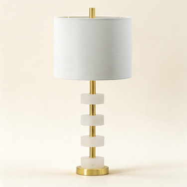 White marble table lamp with four stacked discs and a white drum shade, lamp off
