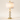 Three-quarter view of the stacked marble table lamp, lamp on