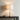 Stacked marble table lamp on a charcoal console with a small ceramic bowl, lamp on