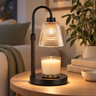 Matte Black Candle Warmer Lamp on a living room side table, warming a jar candle