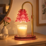 Pink Glass Tree Candle Warmer Lamp glowing on a pale oak dresser in the evening