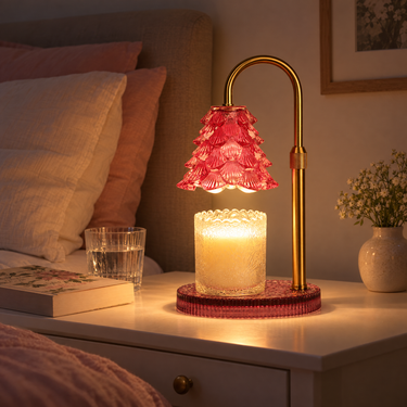Pink Glass Tree Candle Warmer Lamp on a white nightstand at night