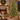 Pre-lit Christmas tree by a fireplace, shown with ornaments added